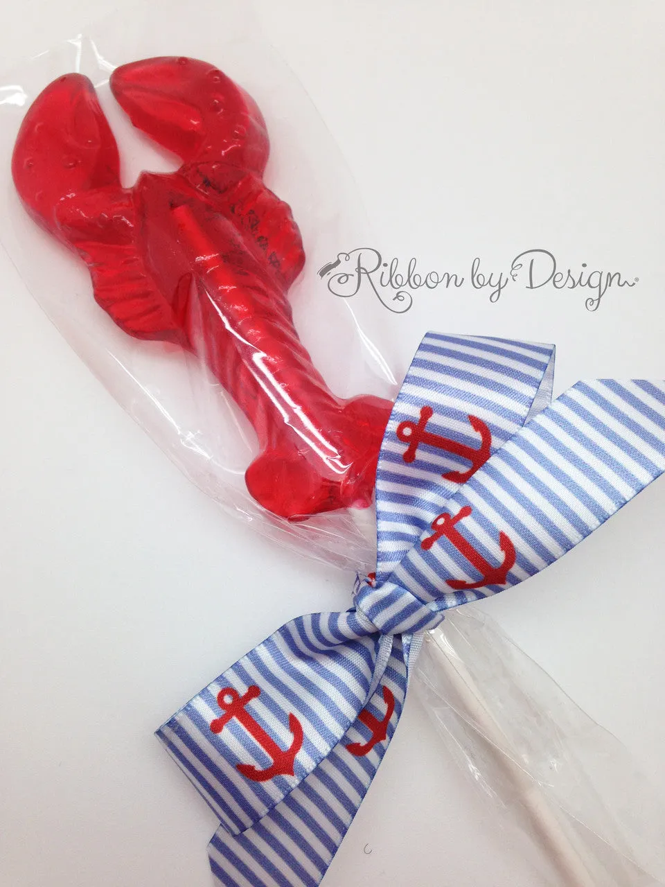 Anchors Ribbon in red on a light blue and white stripe background on 7/8" White Single Face Satin ribbon